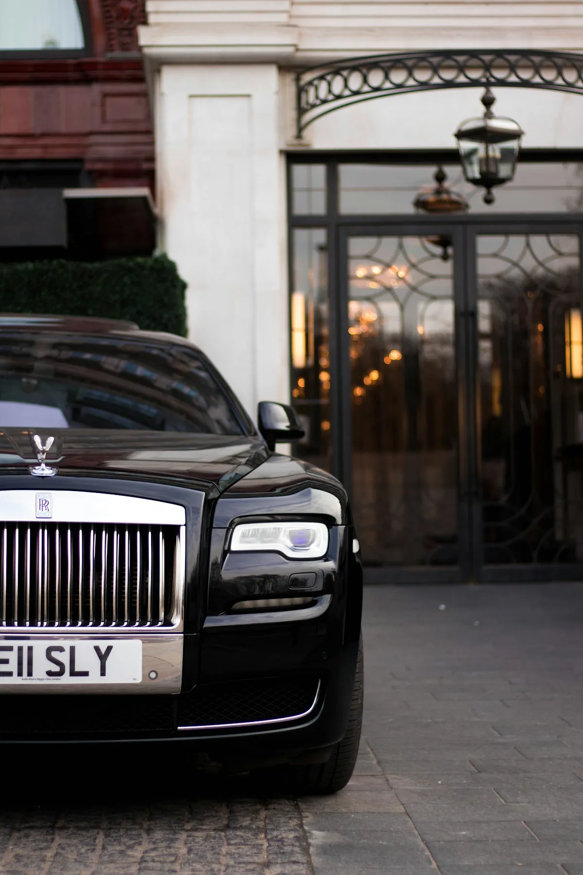 Premium chauffeur-driven car waiting outside a hotel