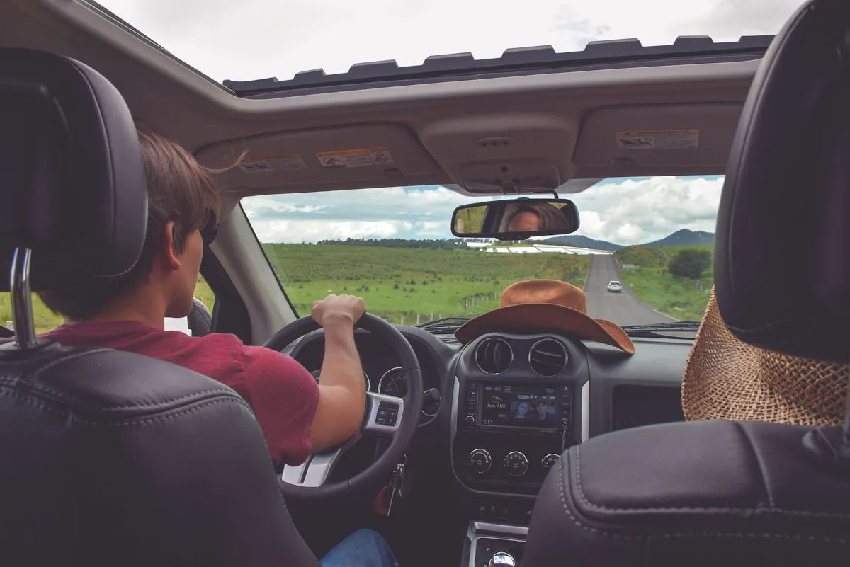 Travellers beginning a scenic road journey by car
