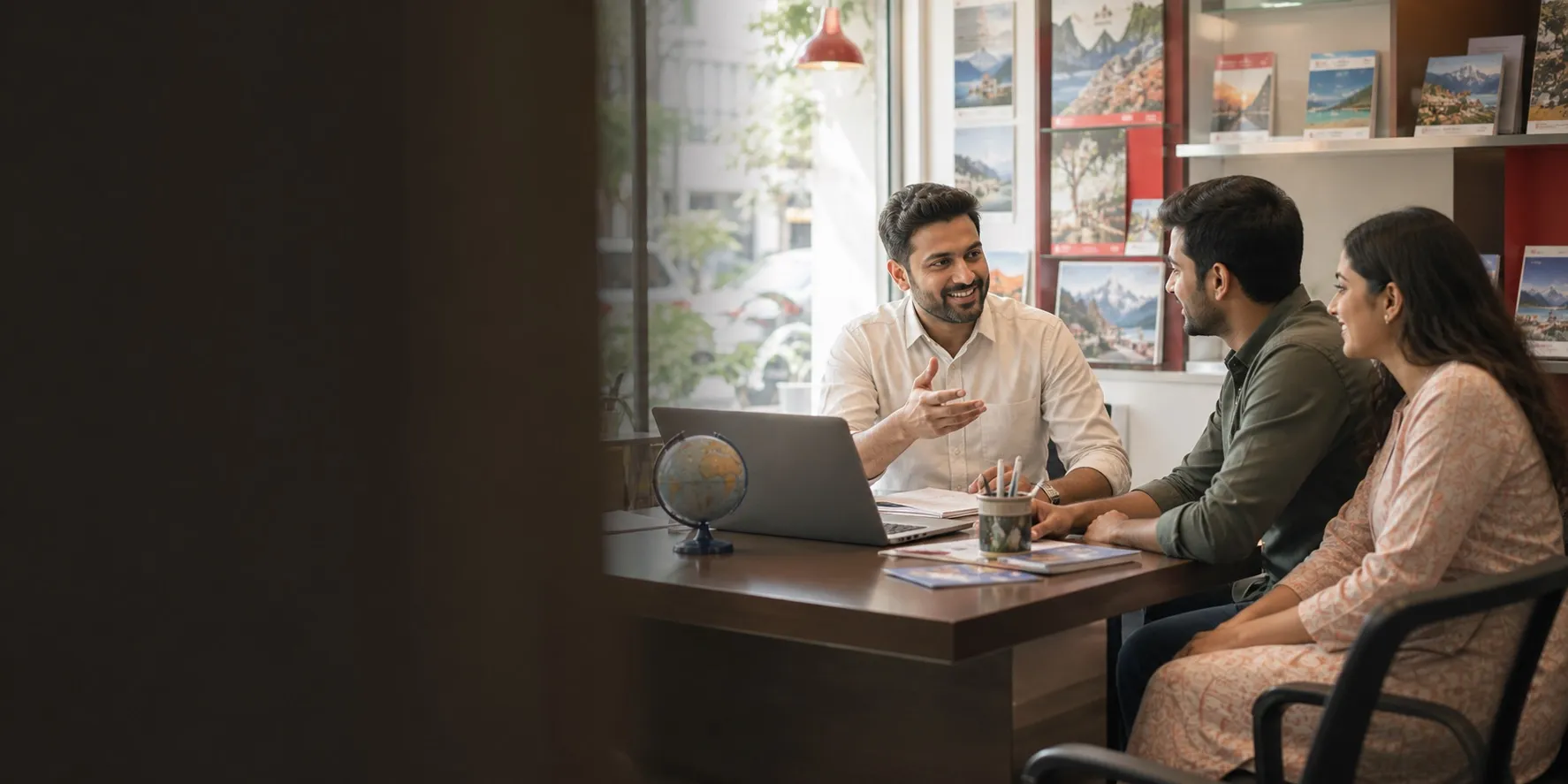 Indian travel franchise owner advising customers in a local travel agency