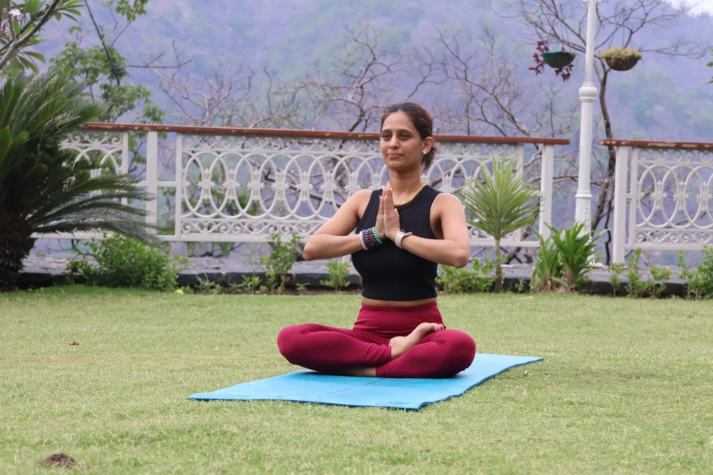 Woman meditating outdoors at a yoga retreat in Rishikesh